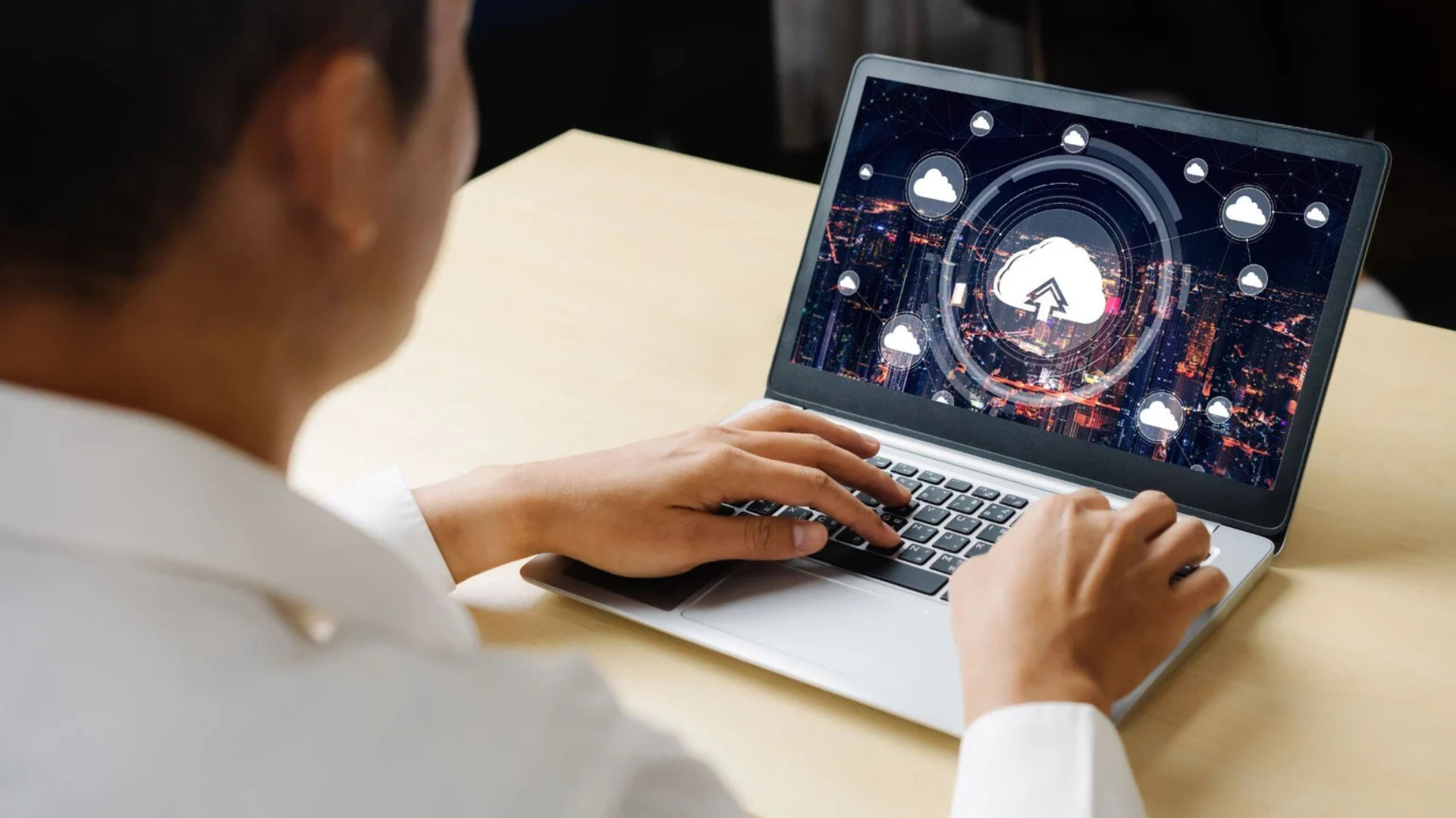 an image showing an individual in the legal industry working on laptop with a screen of cloud upload view