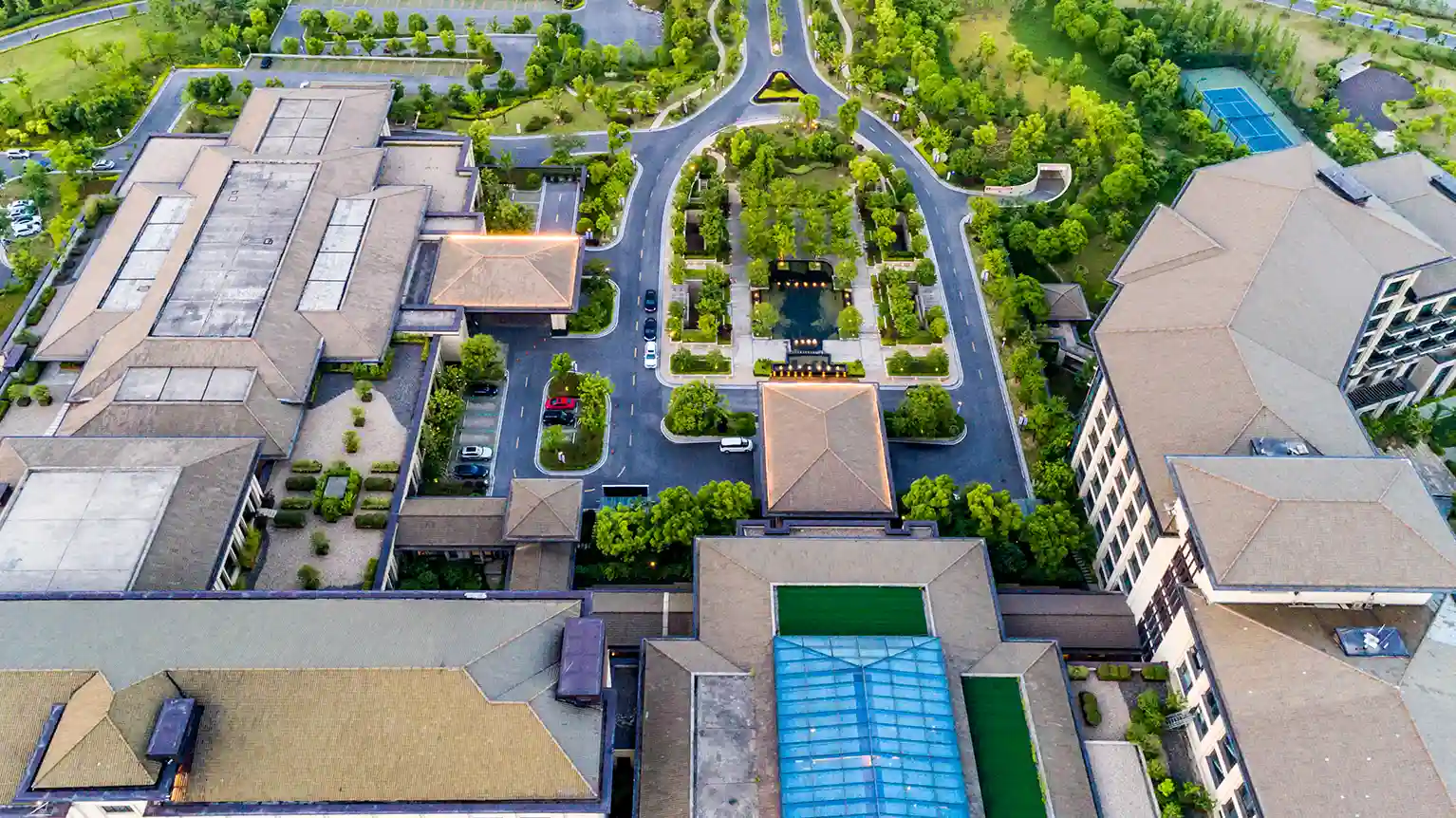 Aerial view of Dayton T. Brown, Inc. facility, showing large industrial buildings, parking lots, and surrounding green space, representing the company's expansive testing, engineering, and technical service operations