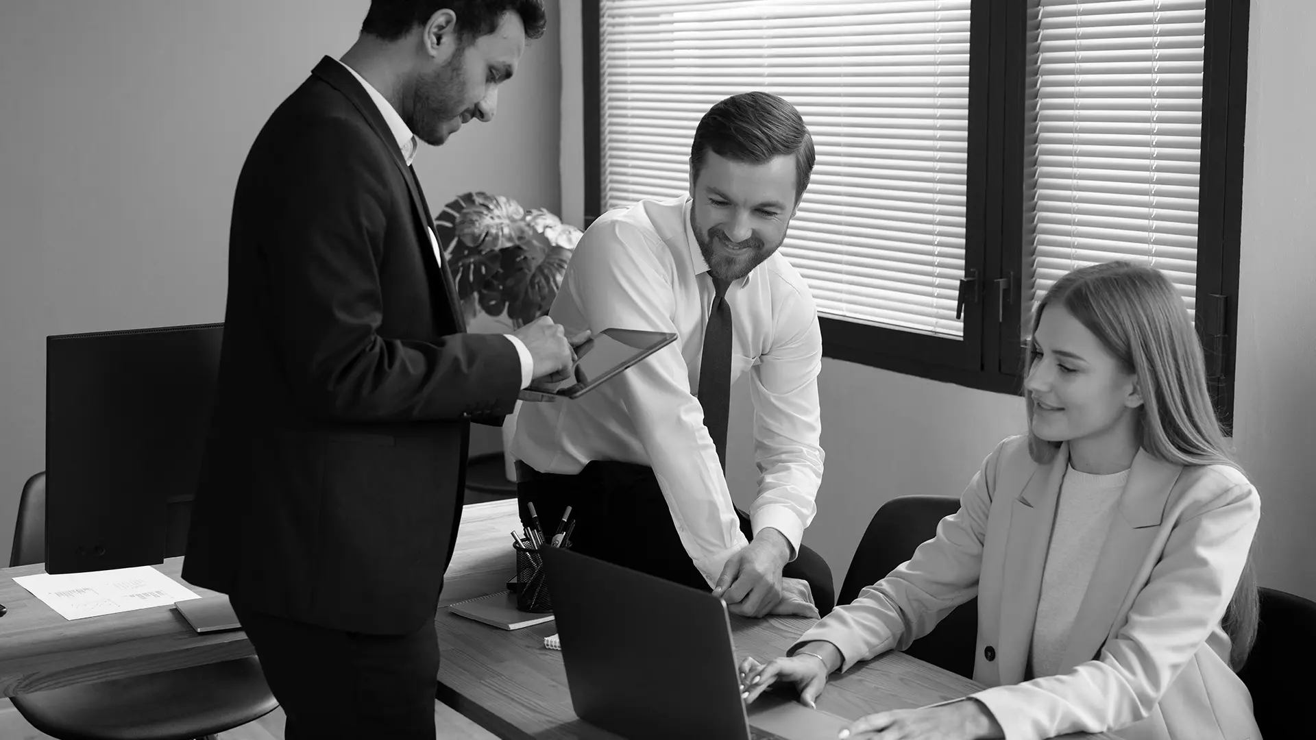 Three professionals in a meeting, discussing documents and working collaboratively, reflecting EDGE Litigation’s focus on strategic consulting and client-centered litigation support