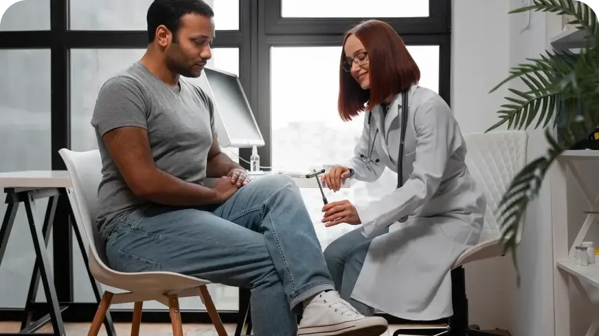 Healthcare professional conducting a knee reflex test on a patient, representing Monument Inc's commitment to personalized, supportive healthcare services