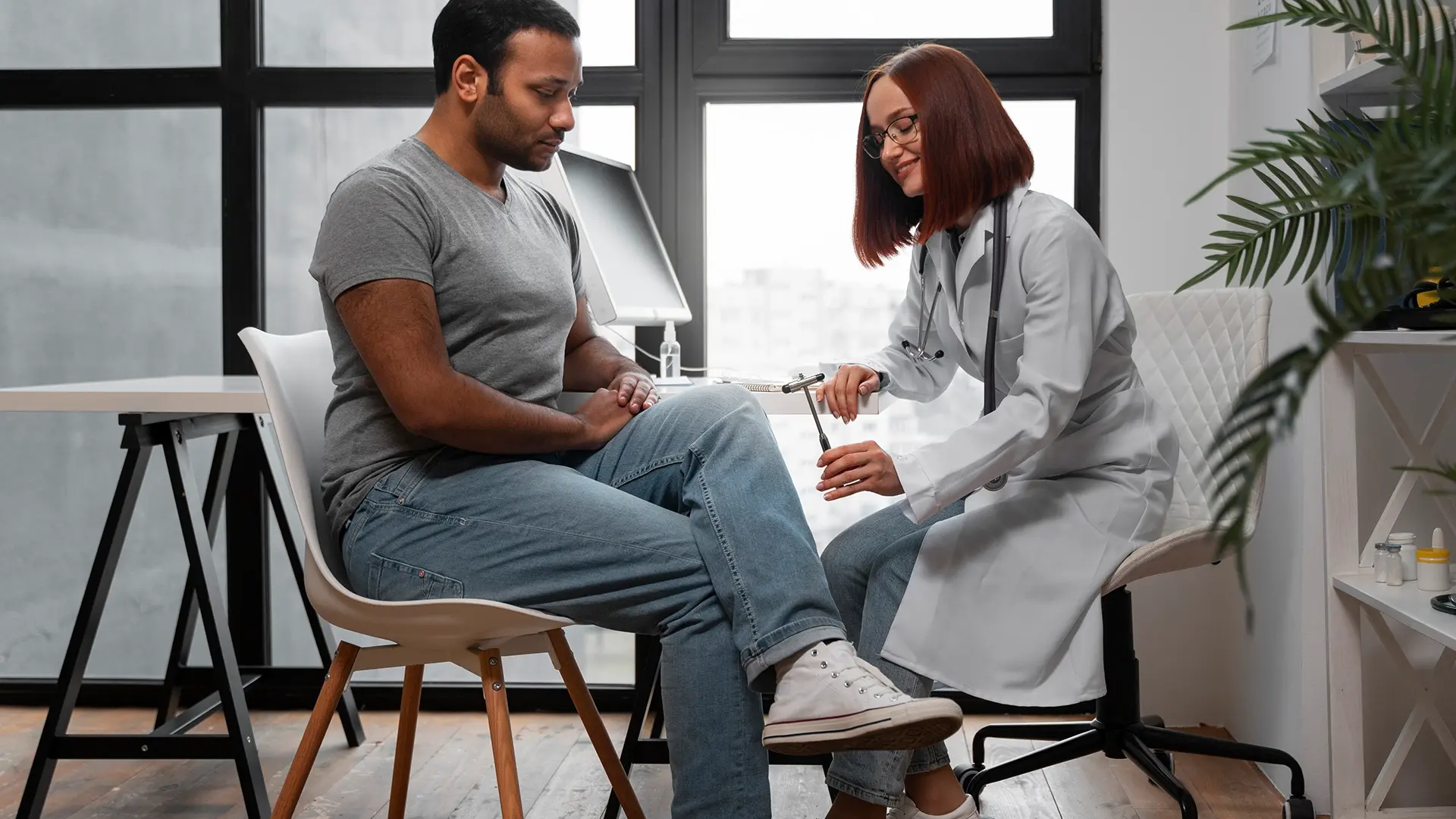 Healthcare professional conducting a knee reflex test on a patient, representing Monument Inc's commitment to personalized, supportive healthcare services