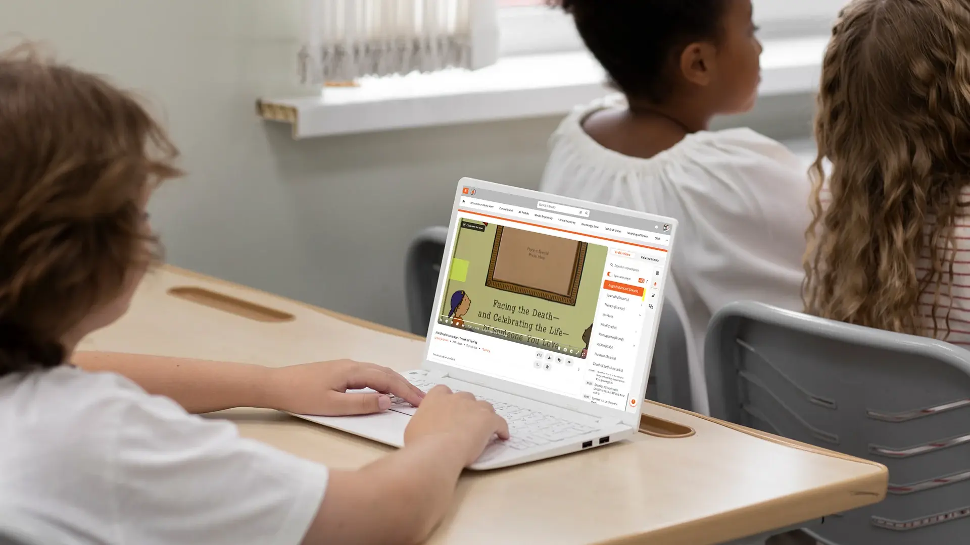 Student watching a classroom video with a multilingual transcript panel showing several language options.