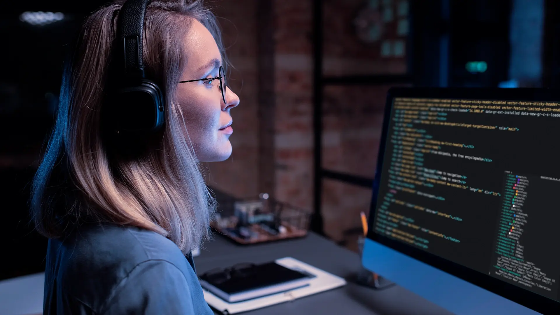 Software developer working on code with focused attention on the screen, representing the innovative software development services provided by OneSoft LLC