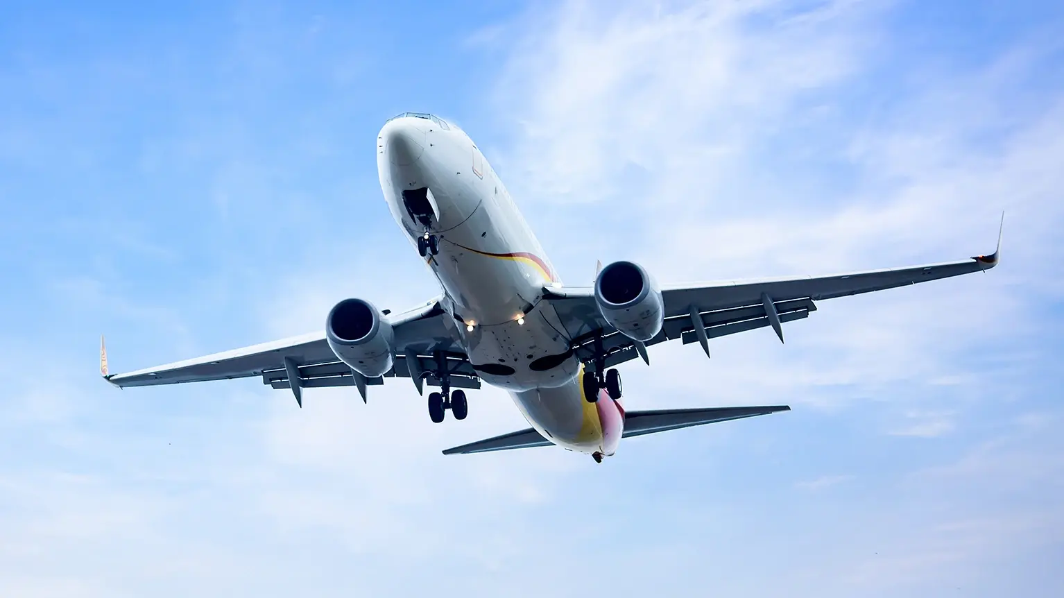 Airplane ascending into a vibrant sky at sunset, symbolizing the innovation and growth in aviation associated with Soar.aero