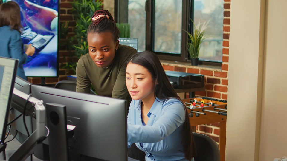 Two person watching a video on a computer