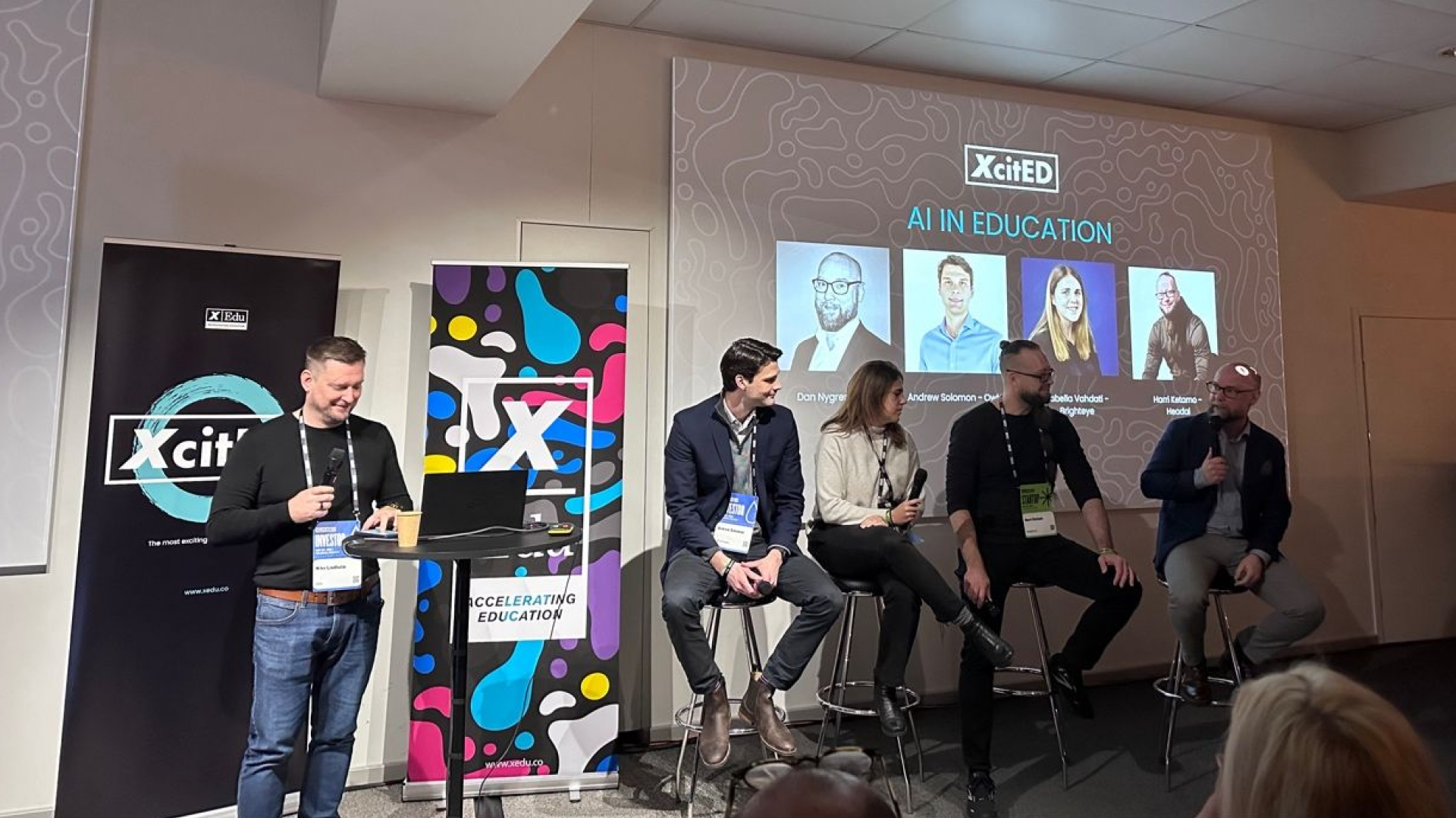 A panel discussion on AI in education at an XcitED event, featuring industry experts and innovators, highlighting advancements and insights in educational technology