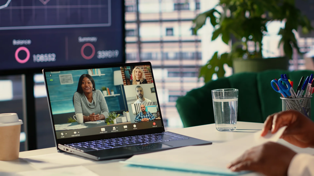 Team conducting customer support and product training through a secure online video portal on a laptop