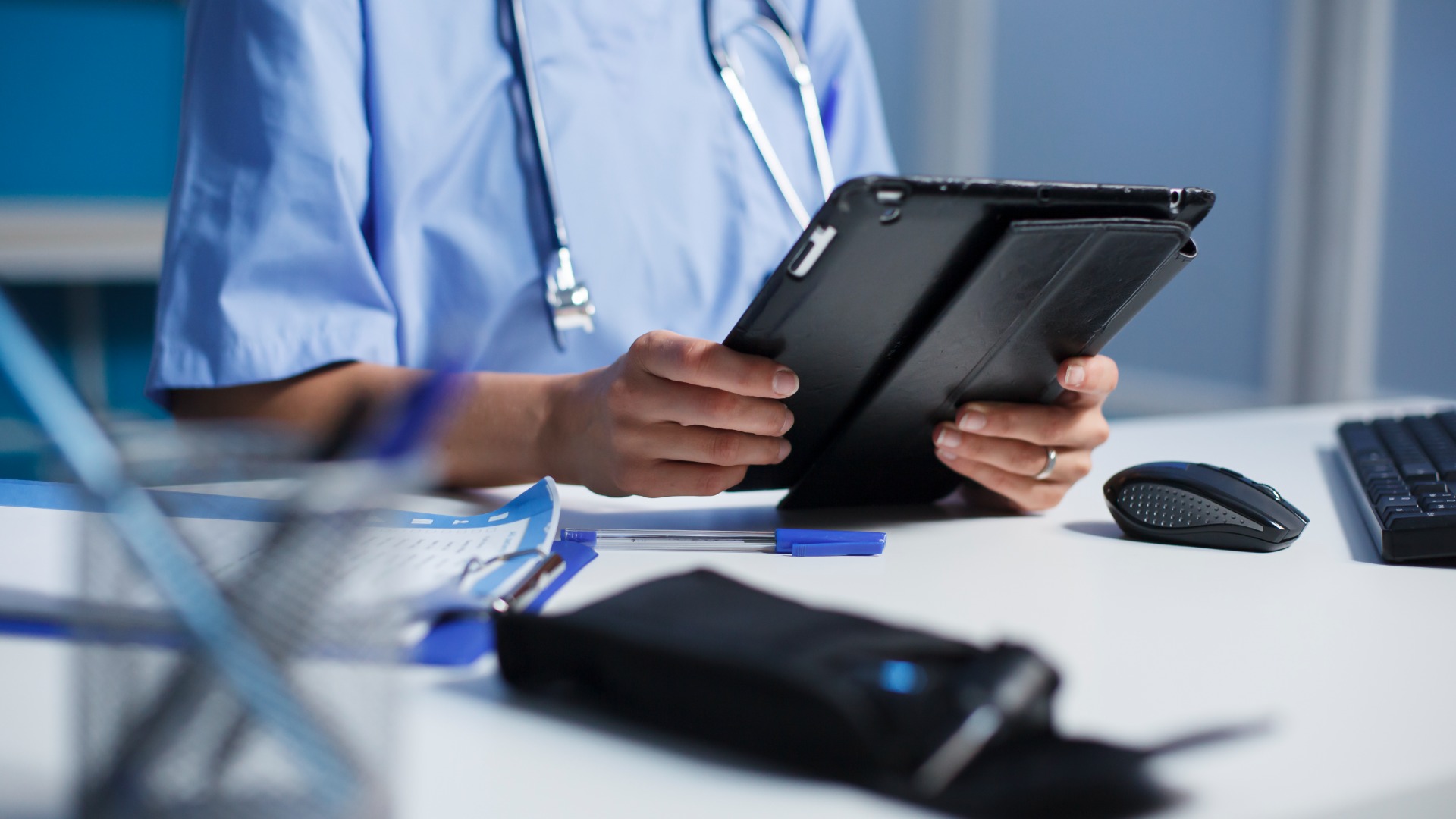 a healthcare worker using a knowledge management platform on a tablet